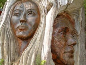 the face of a woman and a man are cared into a tree trunk by maoris in New Zealand exemplifying our eternal face glimpsed during meditation.